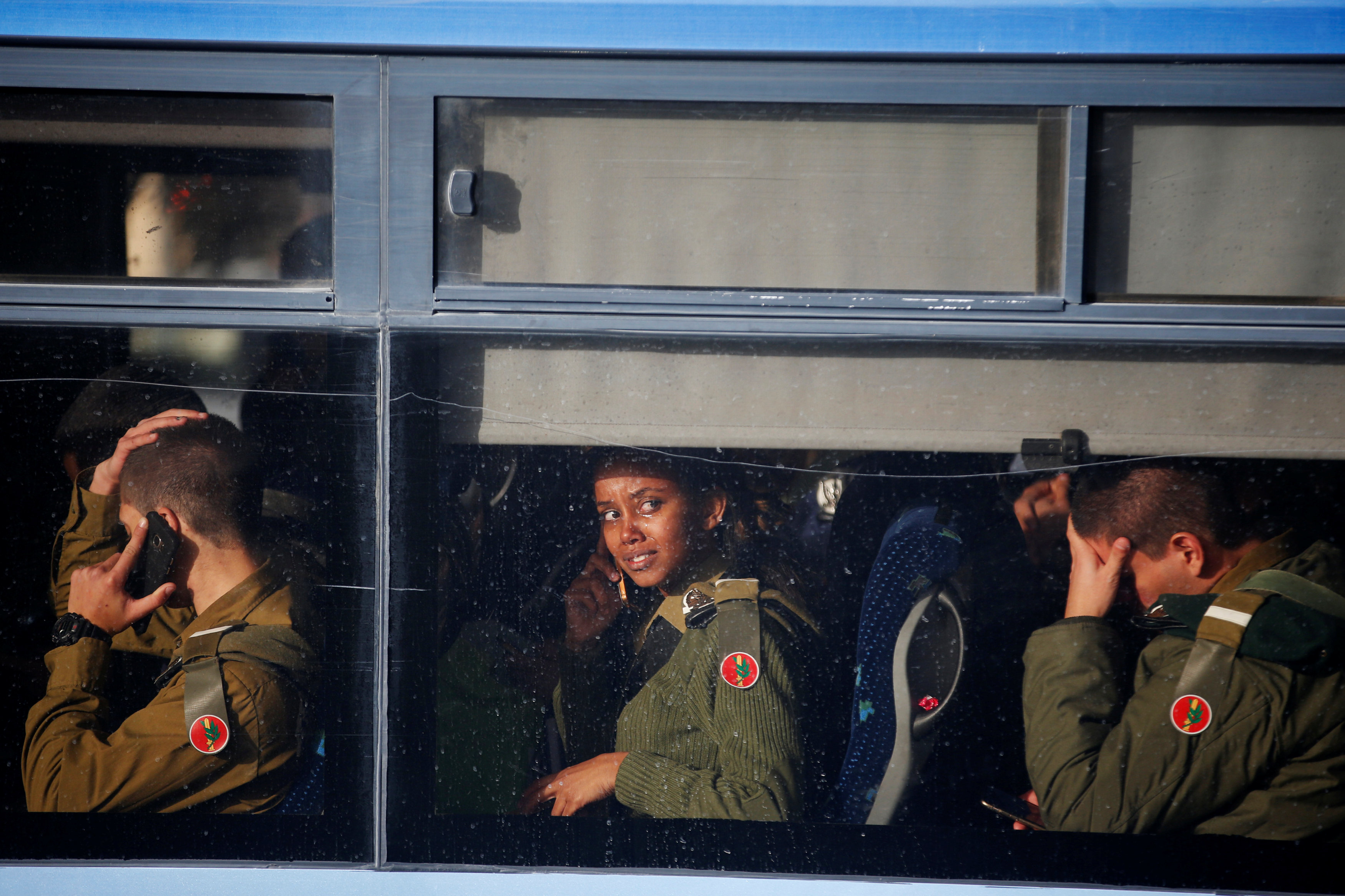 جنود اسرائيليون يستقلون حافلة بعد مغادرتهم موقع حادث الدهس فى القدس