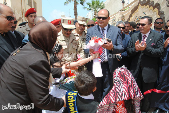 التلاميذ فى استقبال المحافظ وقائد المنطقة الغربية وتقديم باقات الزهور لهما -اليوم السابع -4 -2015