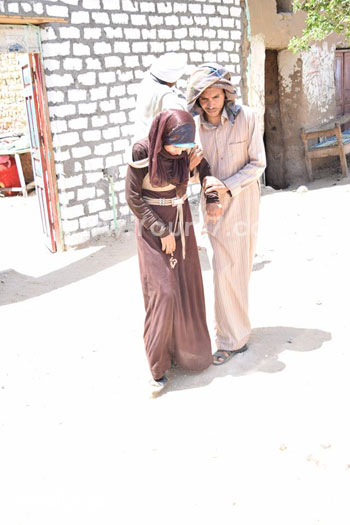 إحدى الفتيات أثناء قيام أحد الأشخاص بمساعدتها للوصول لعربة الإسعاف -اليوم السابع -5 -2015