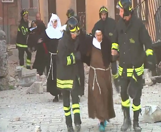 رجال الحماية المدنية يساعدون راهبات عقب تصدع إحدى المبانى الاثرية الإيطالية بسبب الزلزال