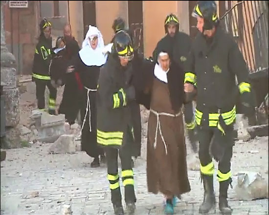  	رجال الحماية المدنية يساعدون راهبات عقب تصدع إحدى المبانى الاثرية الإيطالية بسبب الزلزال