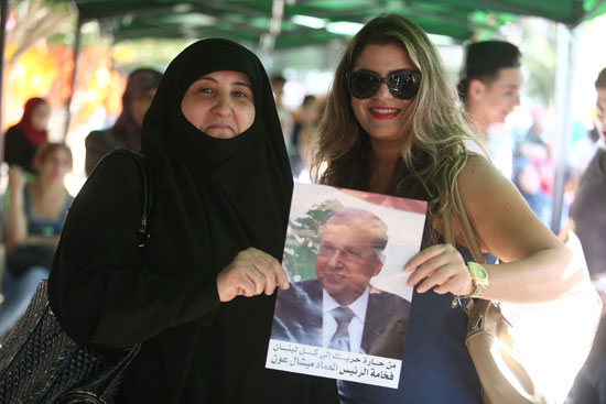 سيدتان لبنانيتان يحملان صورة الرئيس عون
