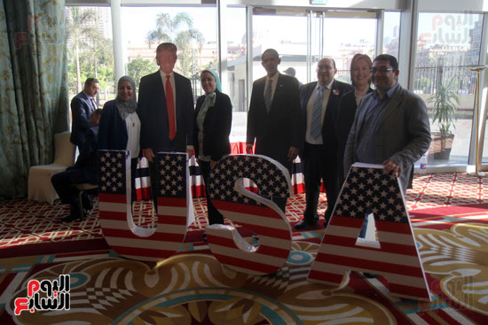 مصريون وأمريكيون يحتفلون بجوار مجسم بفوز ترامب