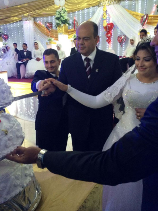 محافظ مطروح يشارك عروسين تقطيع تورتة الزفاف الجماعي