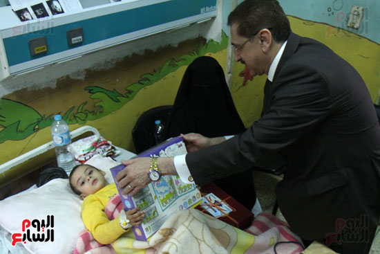  اللواء طارق عطية مع طفل مريض بمستشفى أبو الريش 