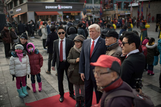 المواطنون يلتقطون الصور التذكارية مع تمثال الشمع لدونالد ترامب فى كوريا الجنوبية
