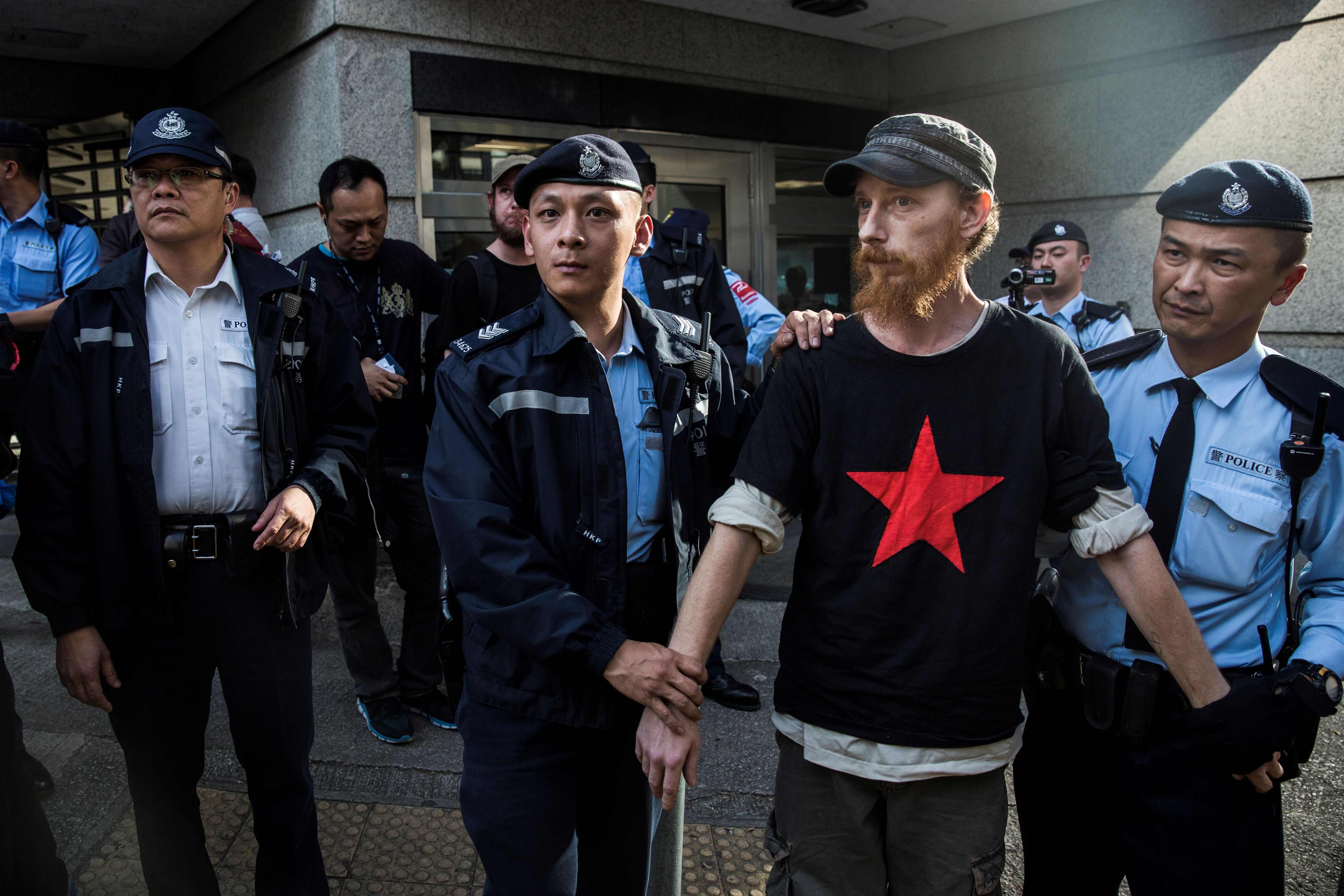 شرطة هونج كونج تعتقل شخص يحمل لافتة ضد ترامب