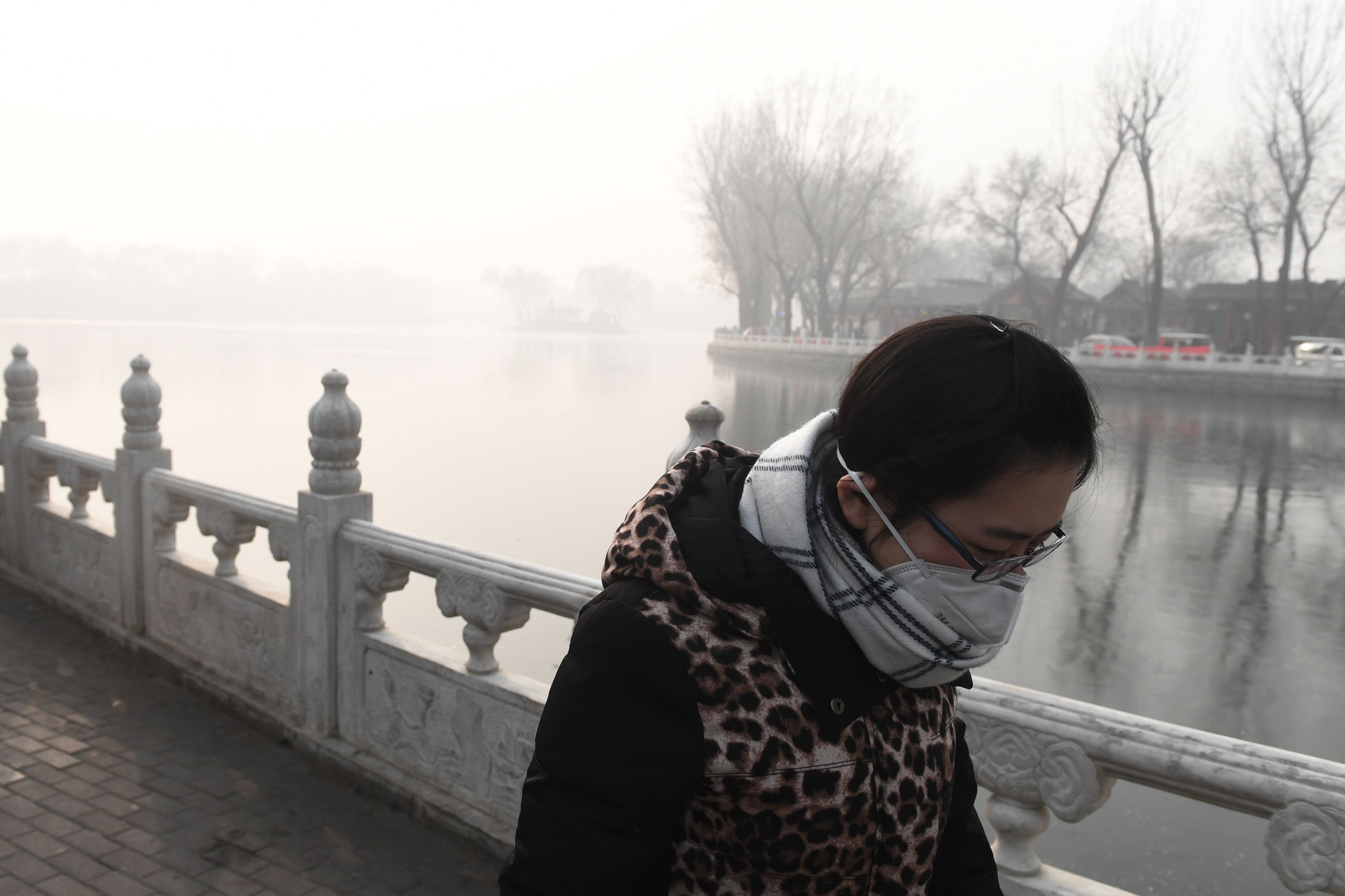 فتاة صينية تستخدم كمامة لمواجهة أدخنة الضباب