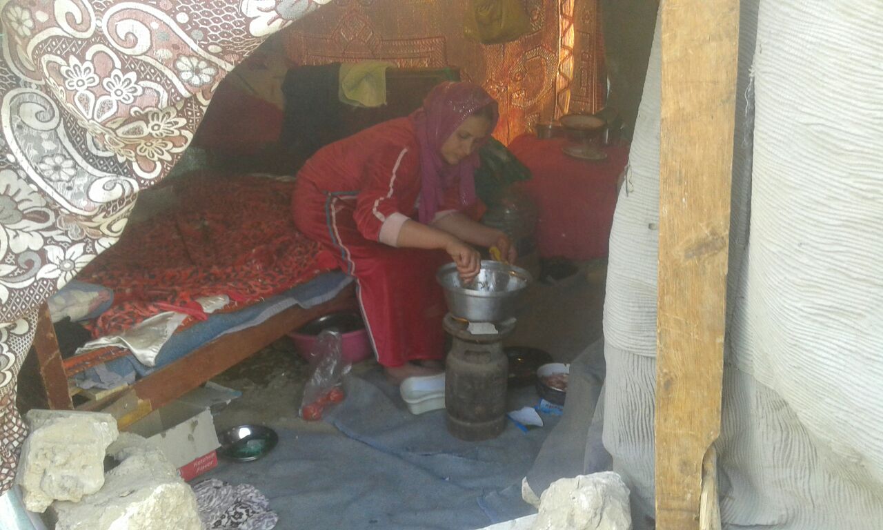 سيدة تطهو الطعام داخل الخيمة