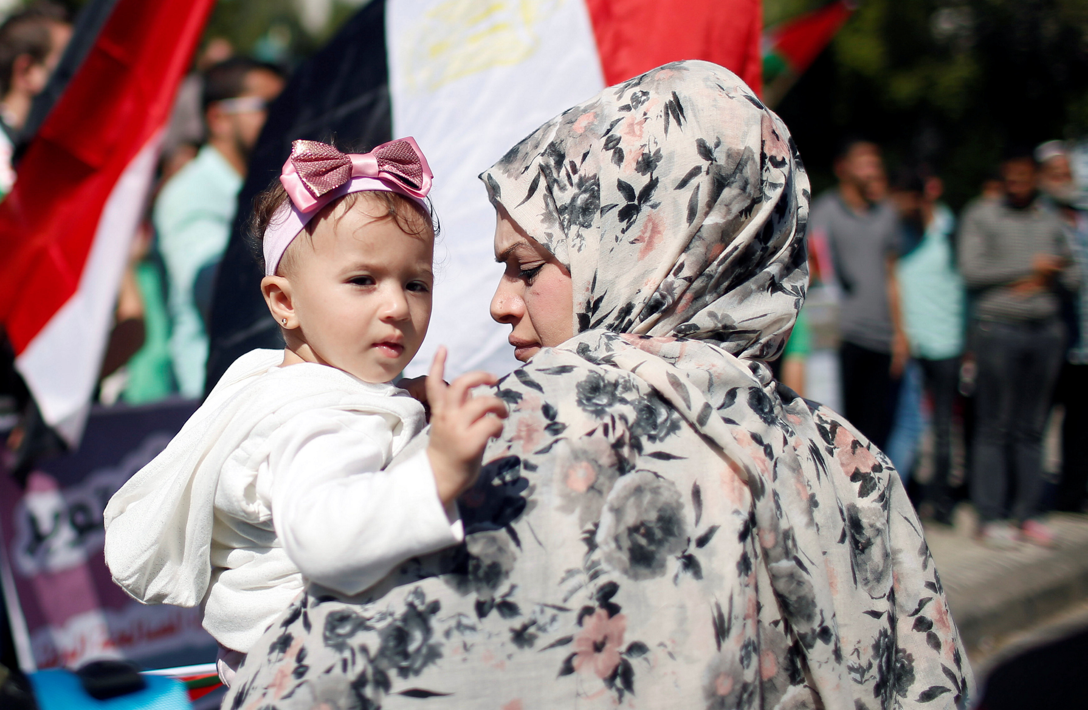 أم تحمل ابنتها خلال احتفالات المصالحة الفلسطينية