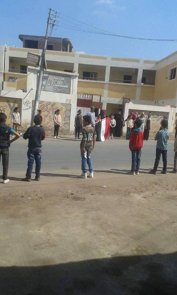3 ألطلاب يحملون علم مصر لتوديع مدرستهم