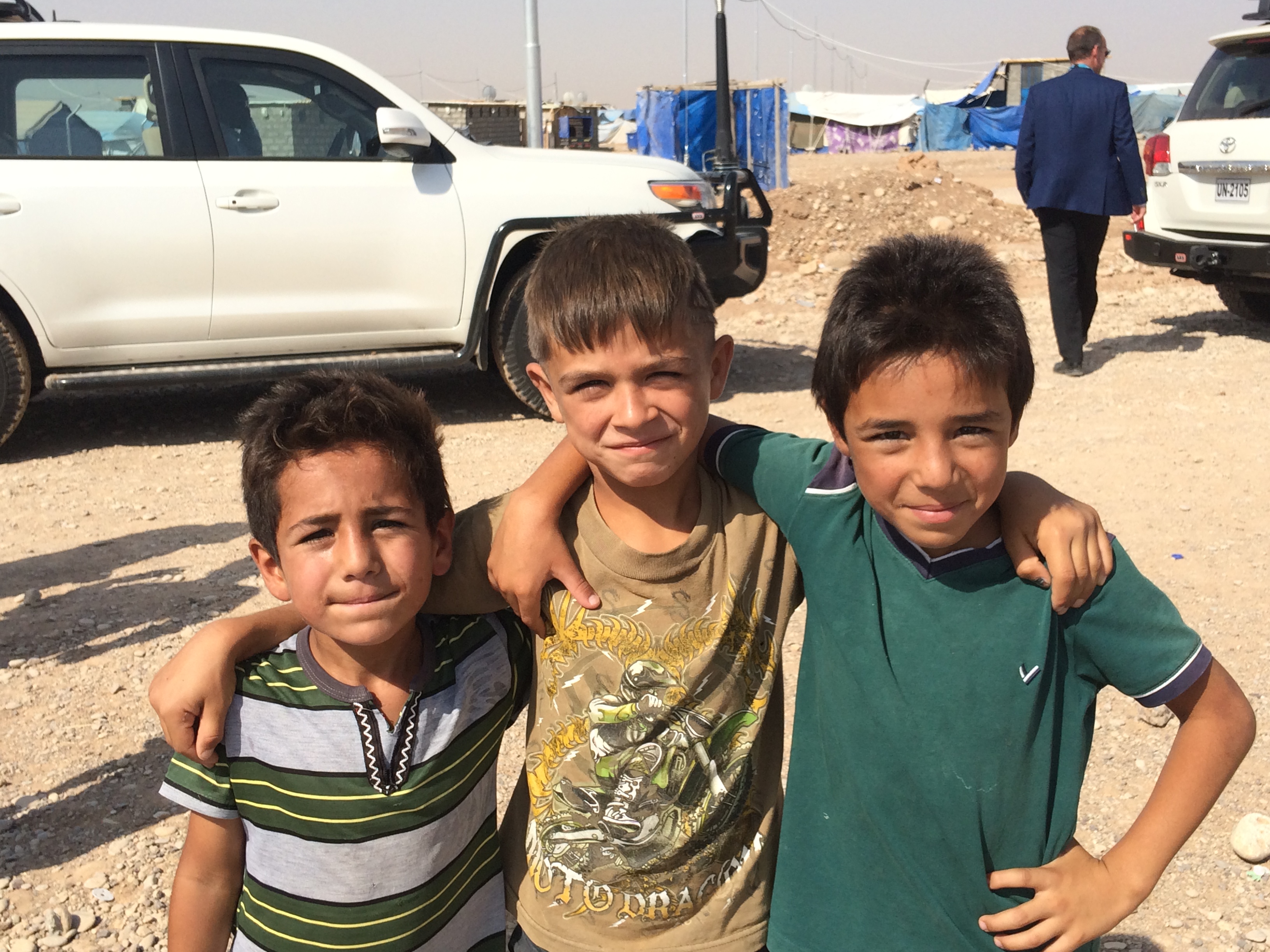 أطفال عراقيين يلتقطون صورة خلال زيارة منظمة دولية