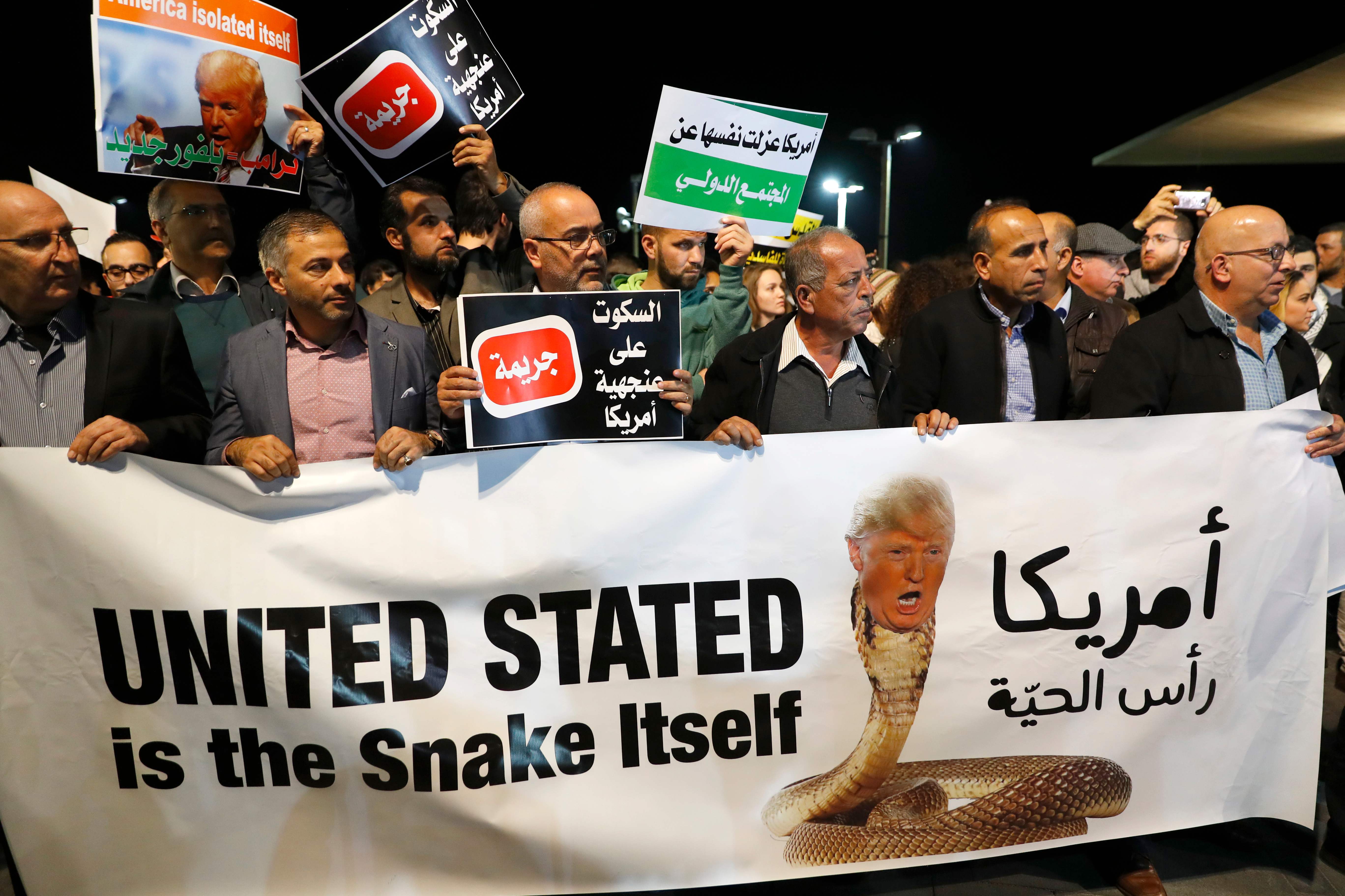 متظاهرون من عرب إسرائيل يرفعون لافتة أمريكا رأس الحية