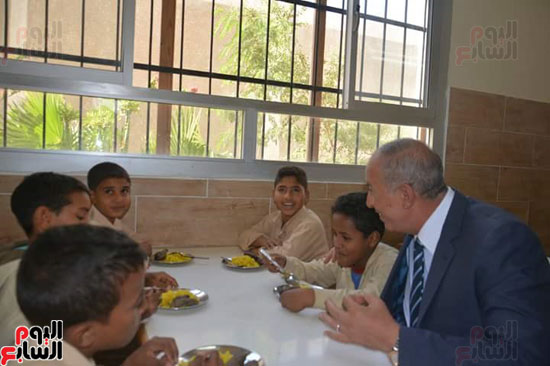  المحافظ مع الطلاب خلال تقديم الوجبات الساخنة لهم 