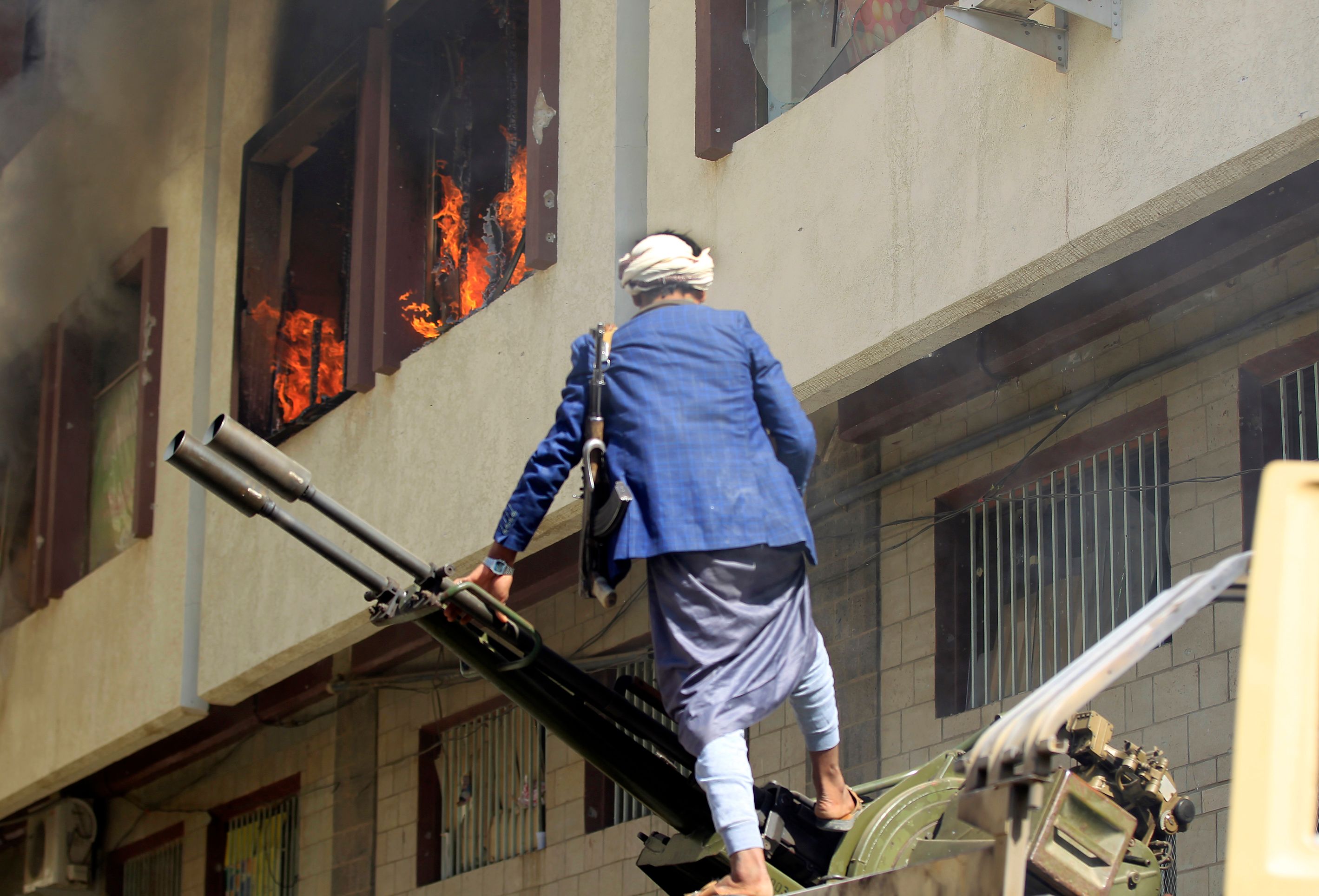 أحد مسلحى الحوثى عقب اشعال النار فى منزل على عبد الله صالح