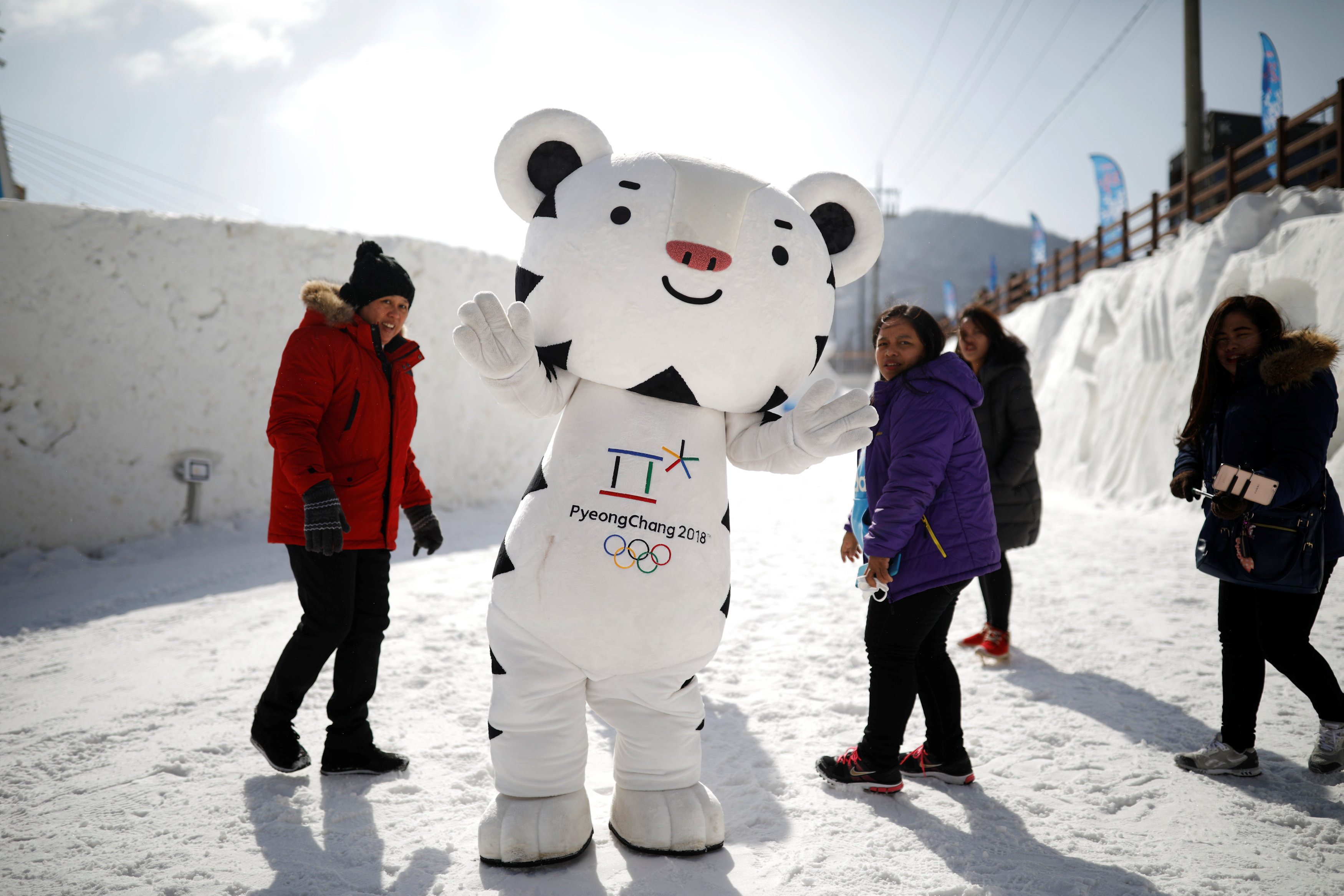 المواطنون يلتقطون الصورة مع دمية الألعاب الأولمبية فى مركز احتفالات الدورة الشتوية 2018