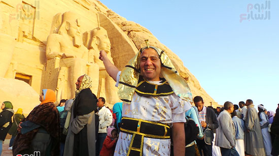 مصرى يرتدى زى فرعونى أمام المعبد
