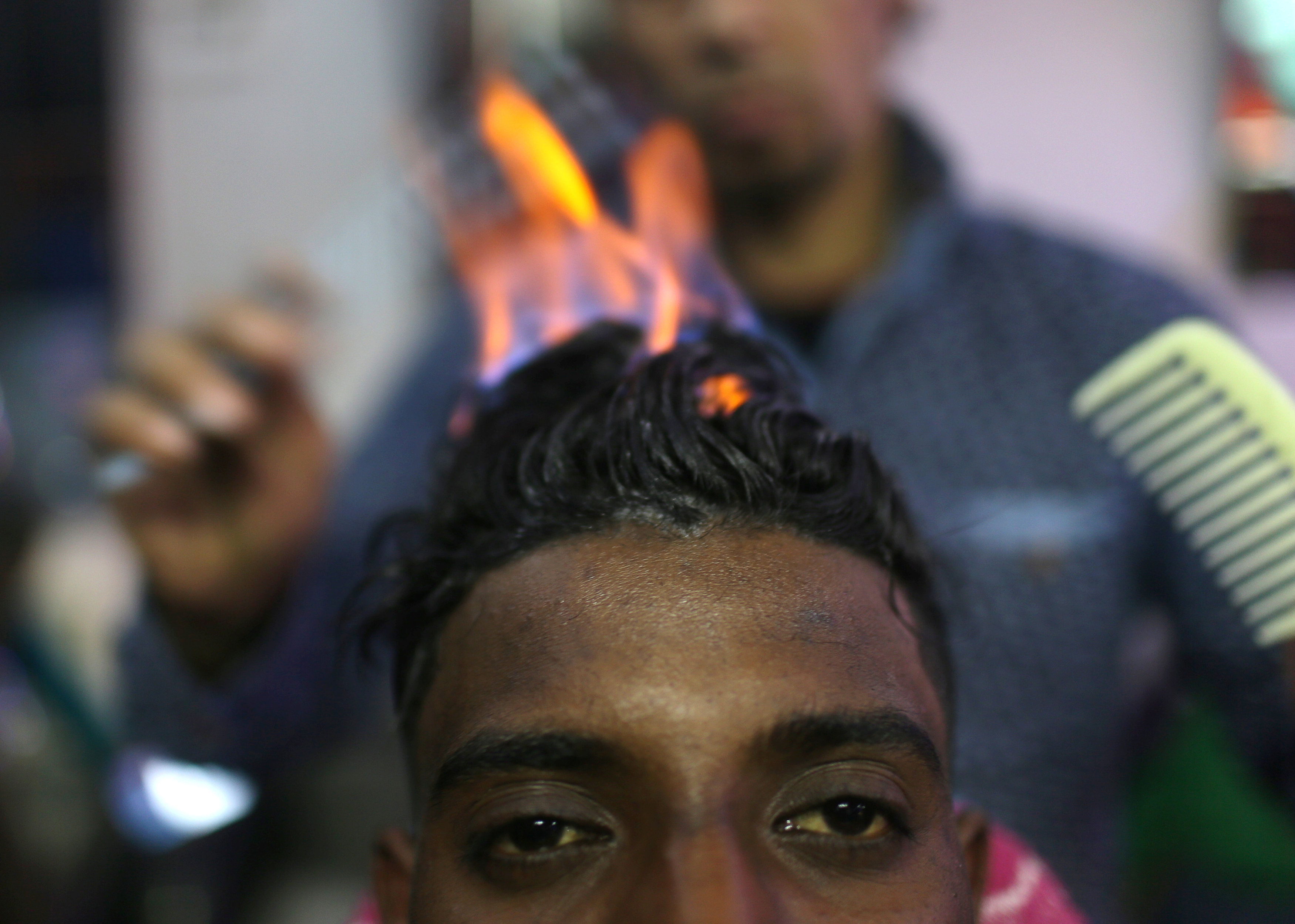 مصفف شعر يستخدم النار فى فرد الشعر