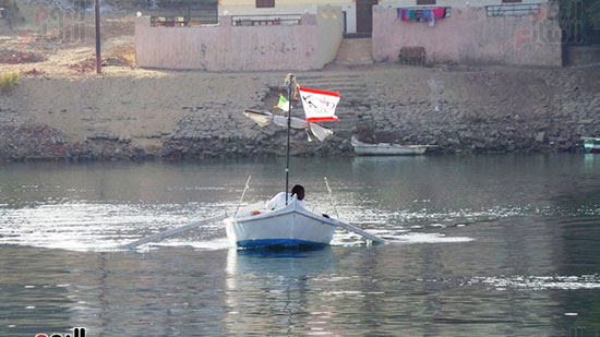 شاب يعبر النيل بقاربه الصغير