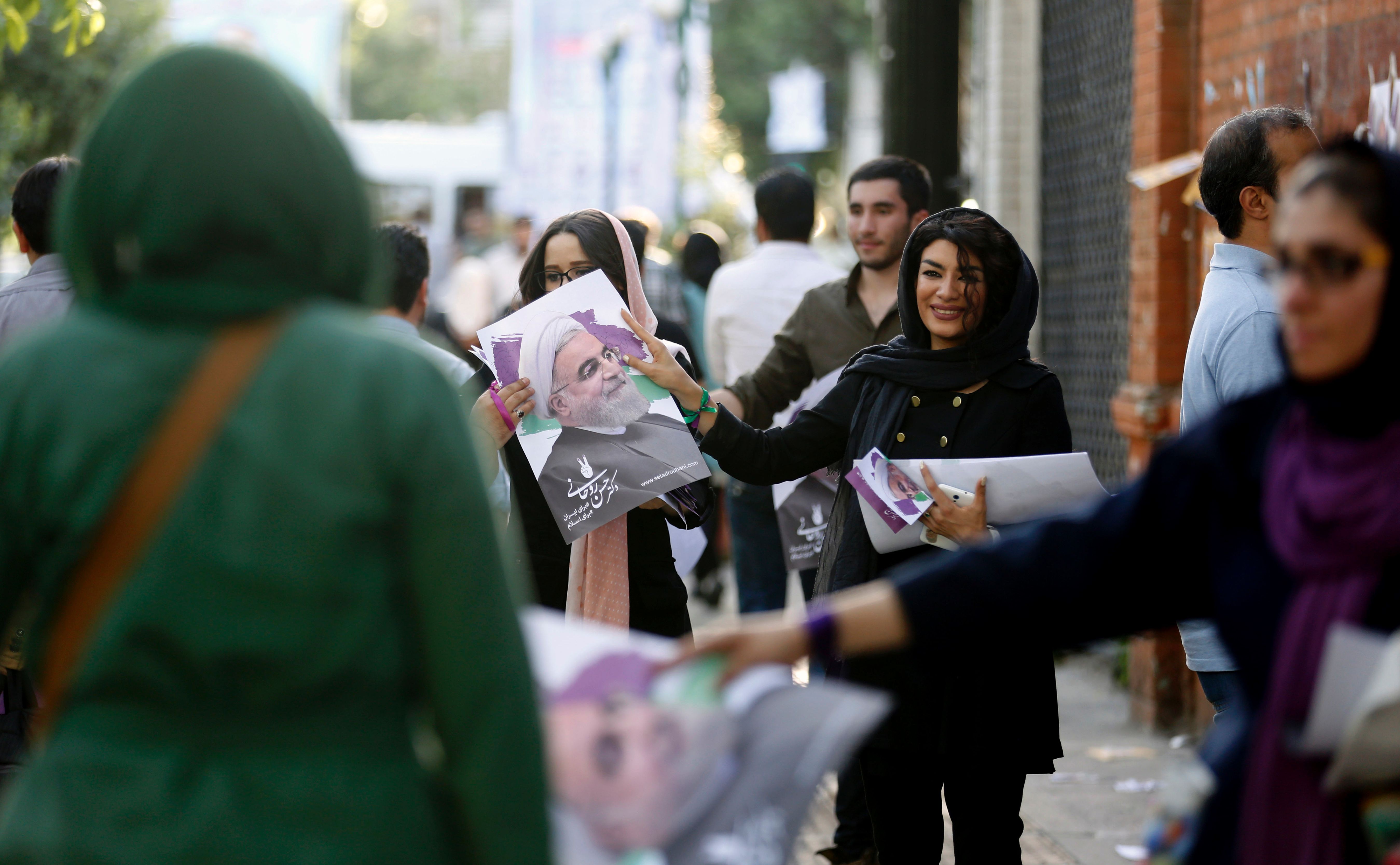 الإيرانيات يواصلن توزيع الدعاية لروحانى