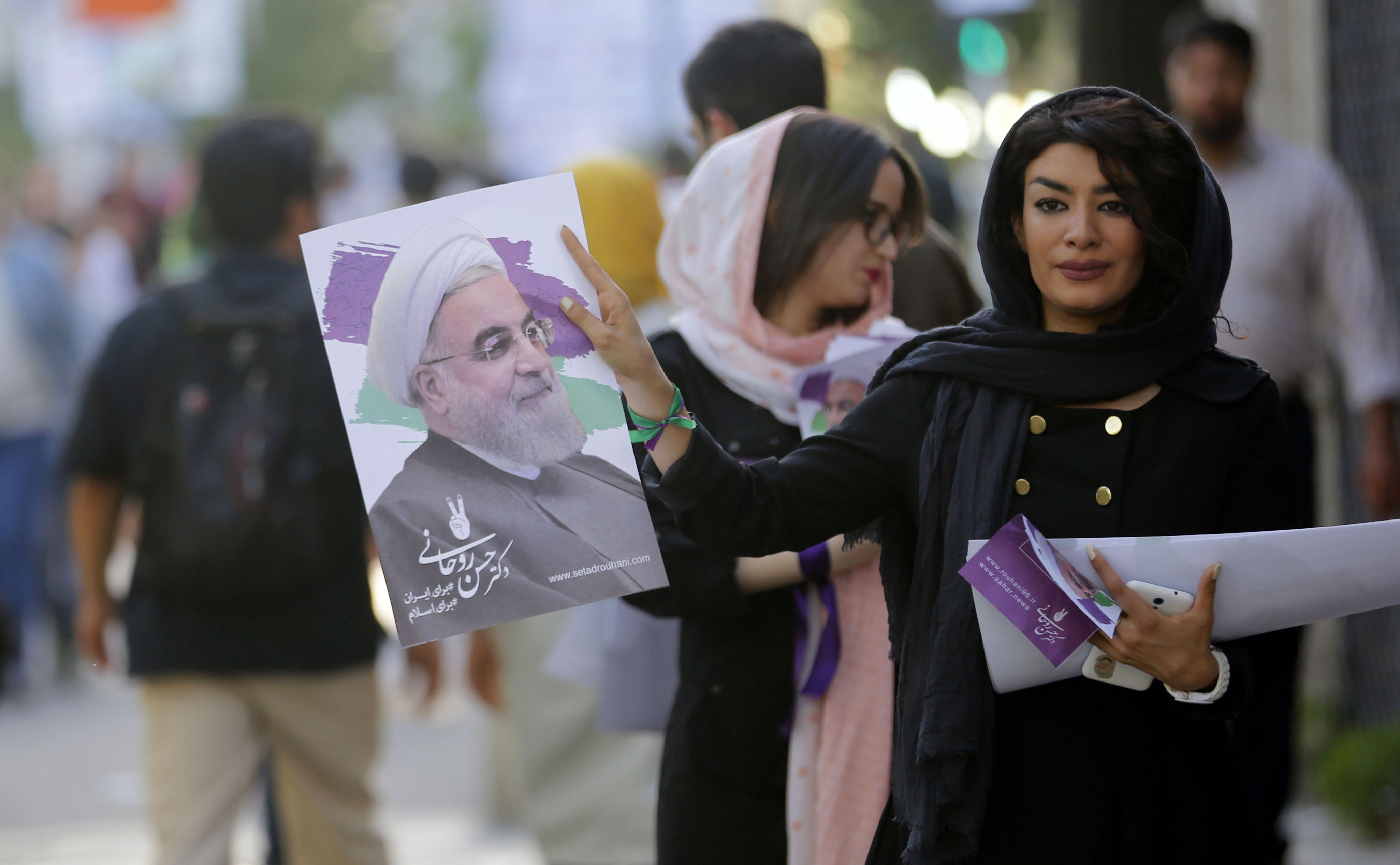 إيرانية توزع دعاية لروحانى