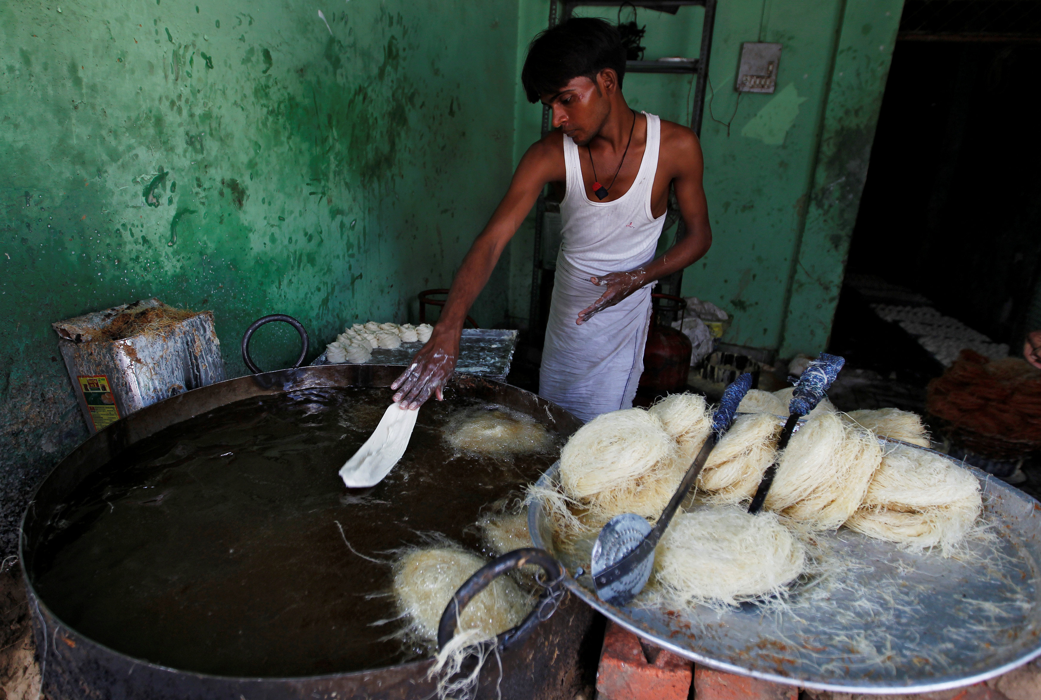 بائع يجهز الحلويات فى الهند