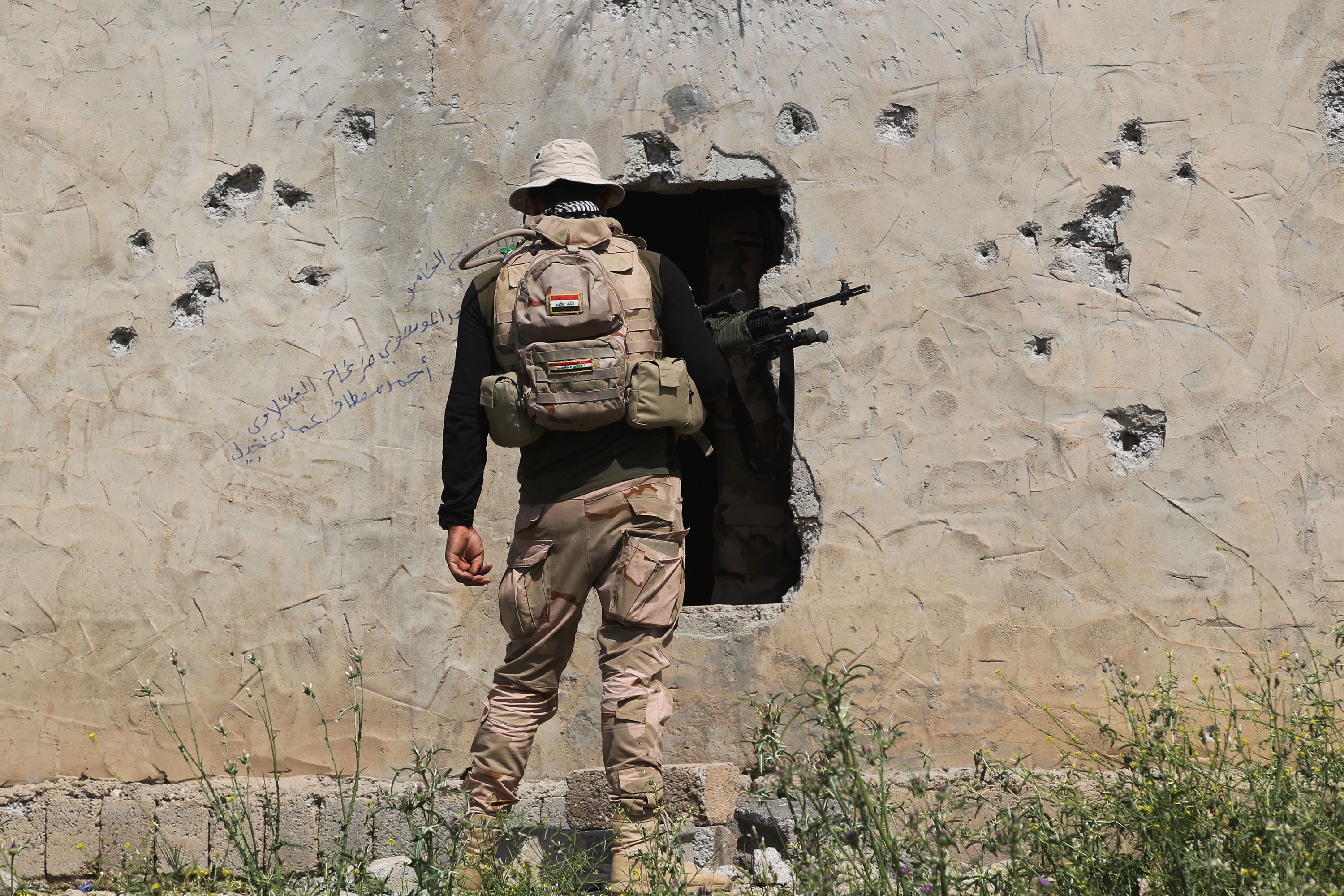 جندى عراقى يفتش أحد المنازل فى الموصل