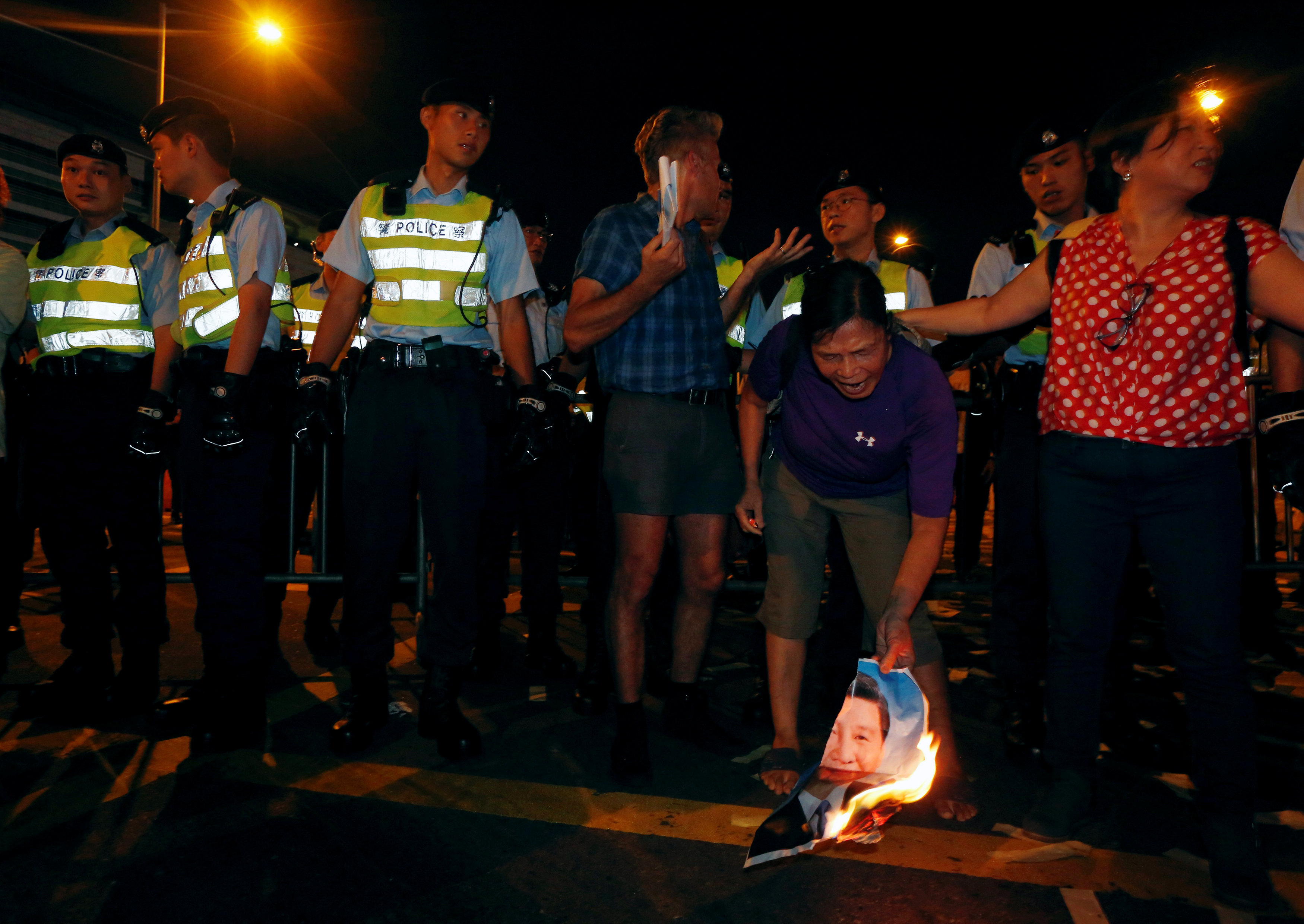 متظاهر يحرق صورة الرئيس الصينى