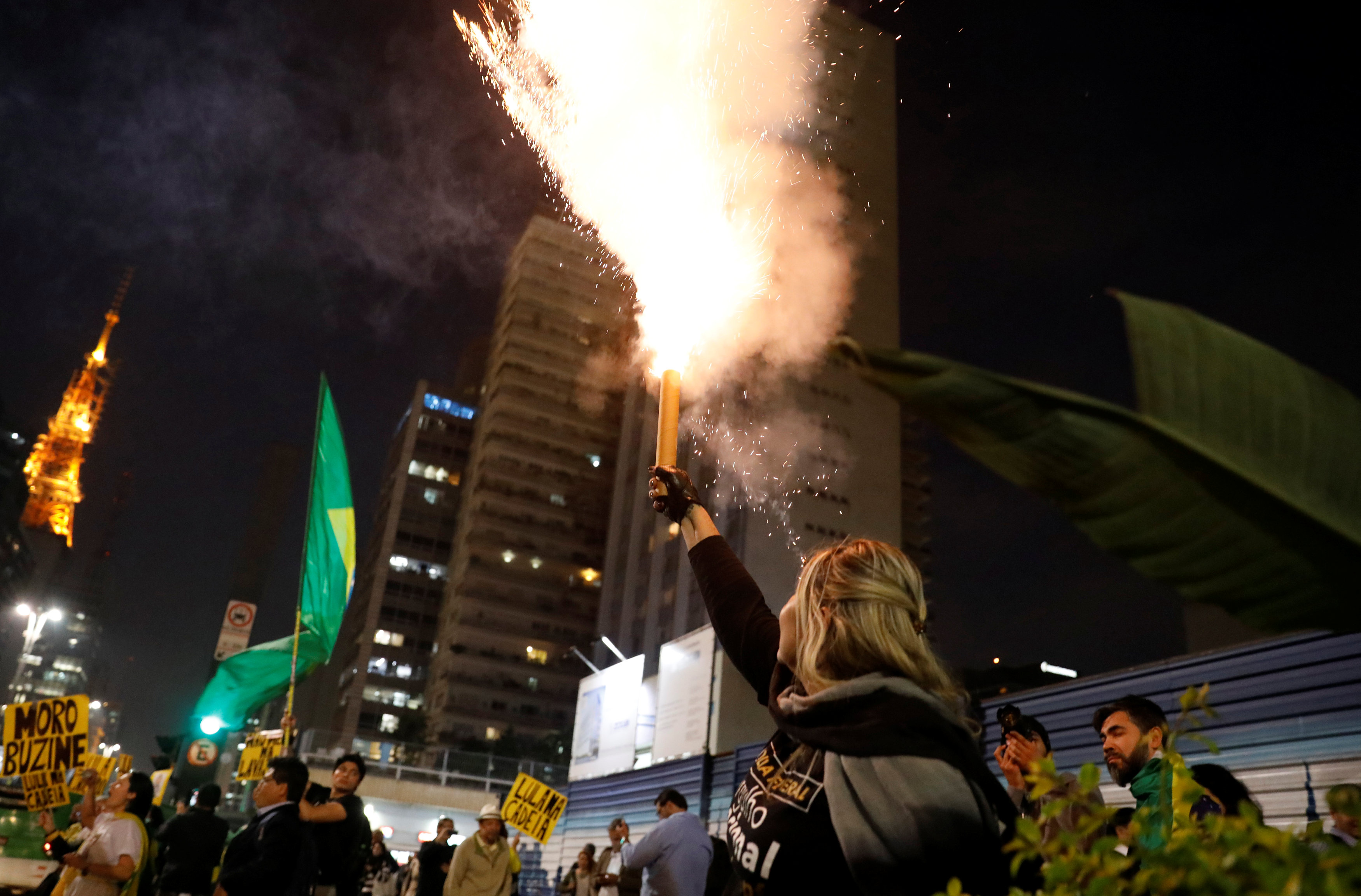 سيدة تطلق الالعاب النارية فى البرازيل احتفالا بالحكم بسجن الرئيس البرازيلى