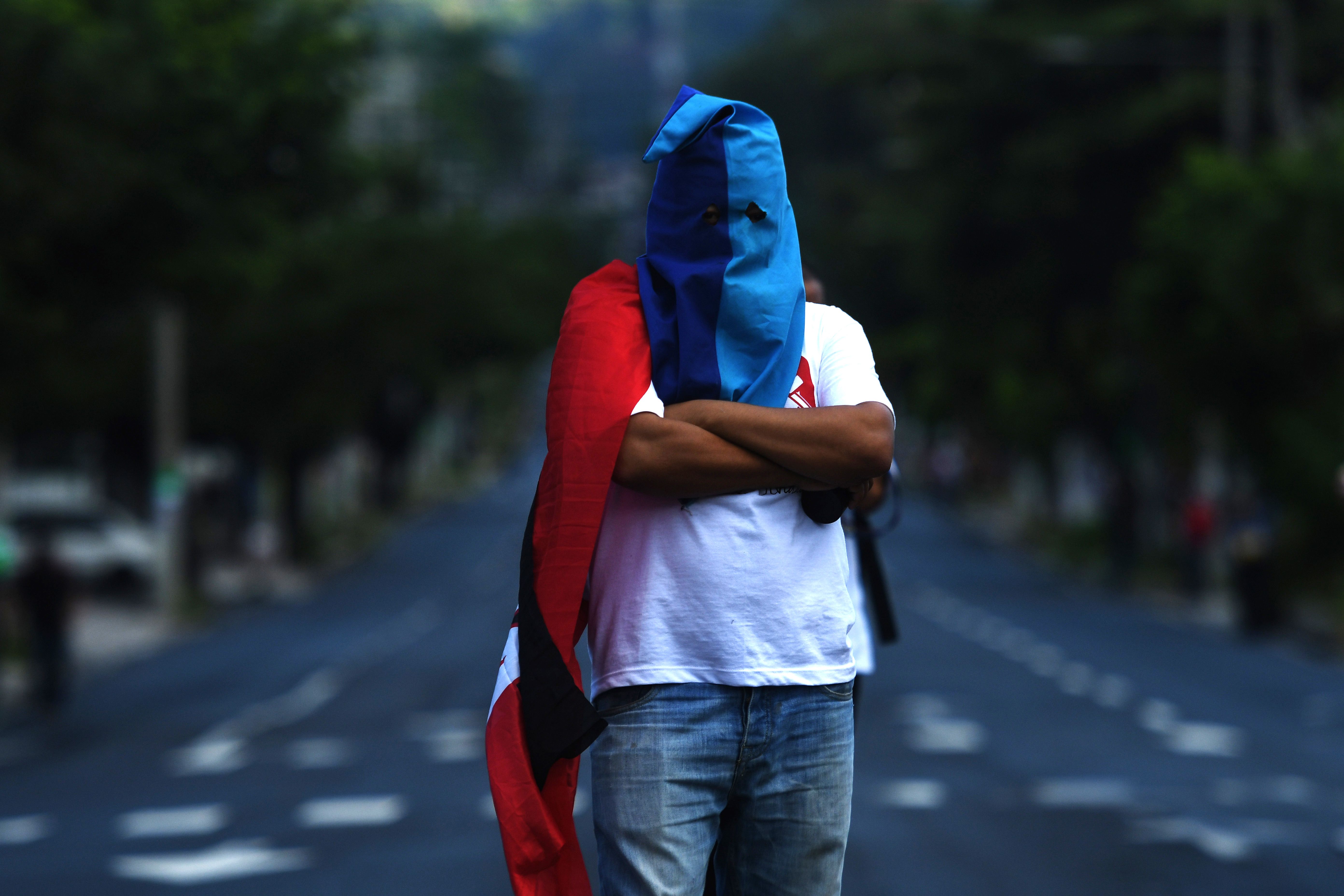 متظاهر يغطى وجهه خلال مسيرة فى السلفادور