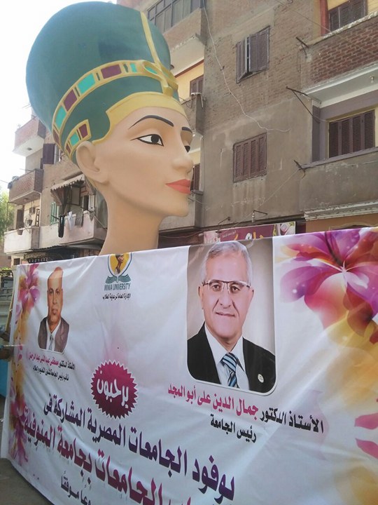 رأس نيفرتيتى ويافطة تحمل صورة رئيس جامعة المنيا