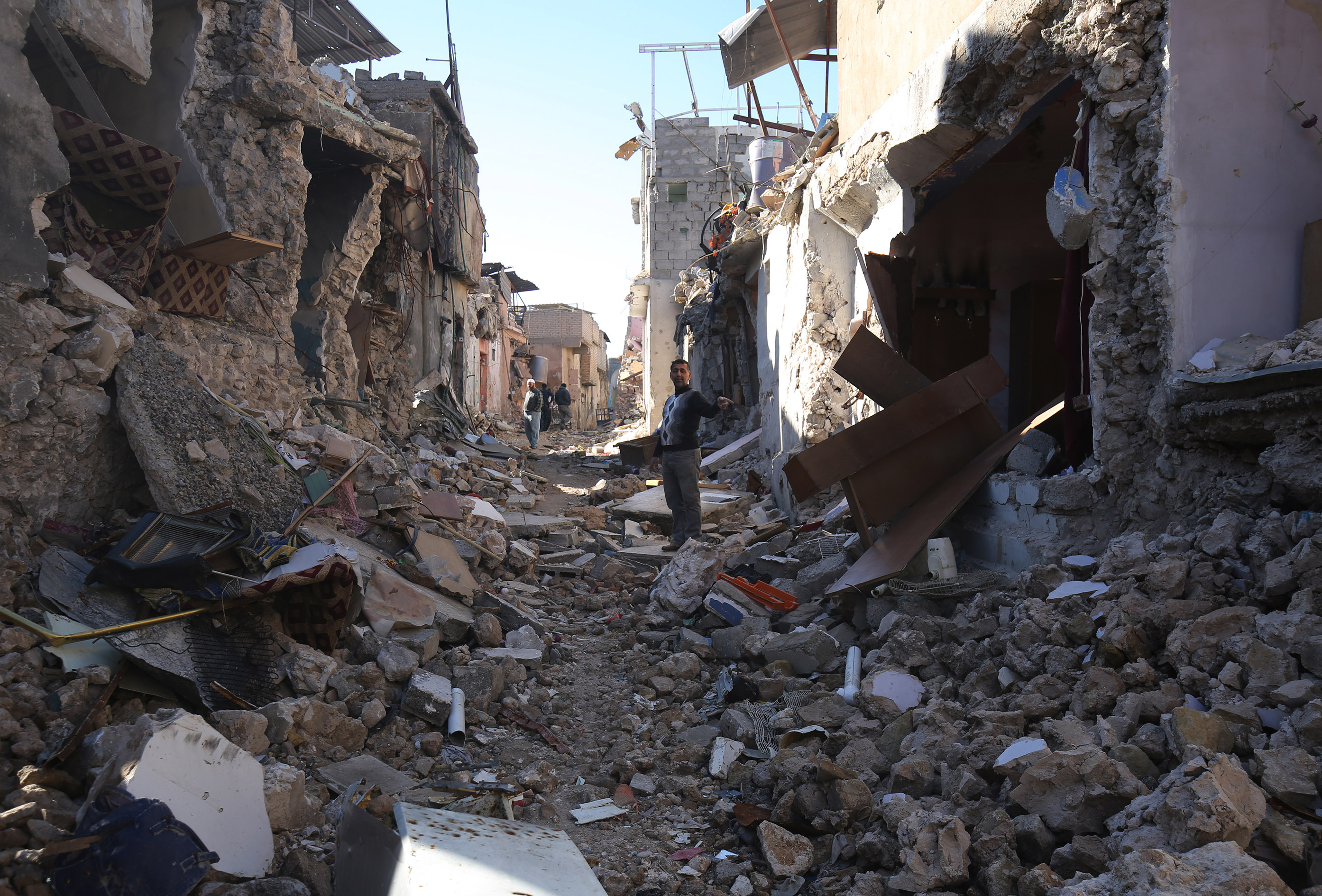 رجل يشير إلى منزله المنهار فى مدينة الموصل
