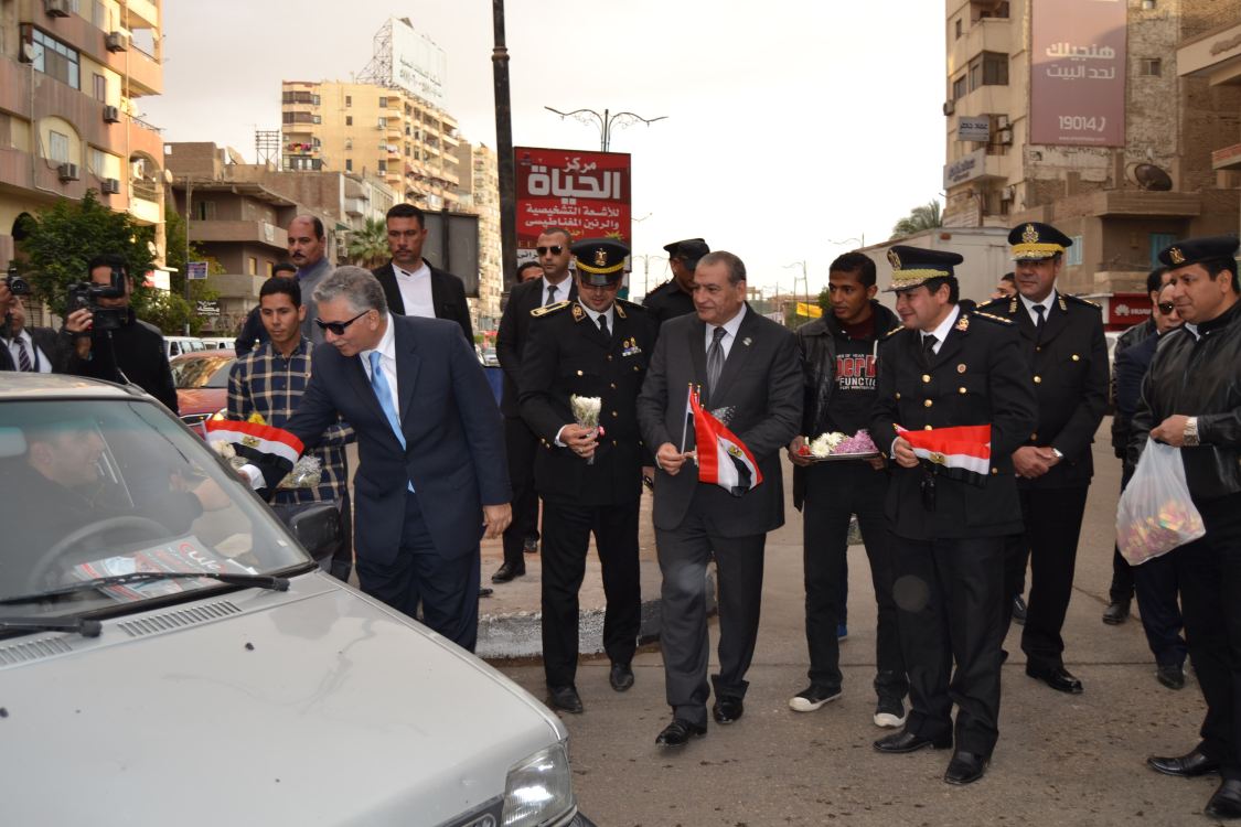 مساعد وزير الداخلية أثناء توزيع الورود علي المواطنين