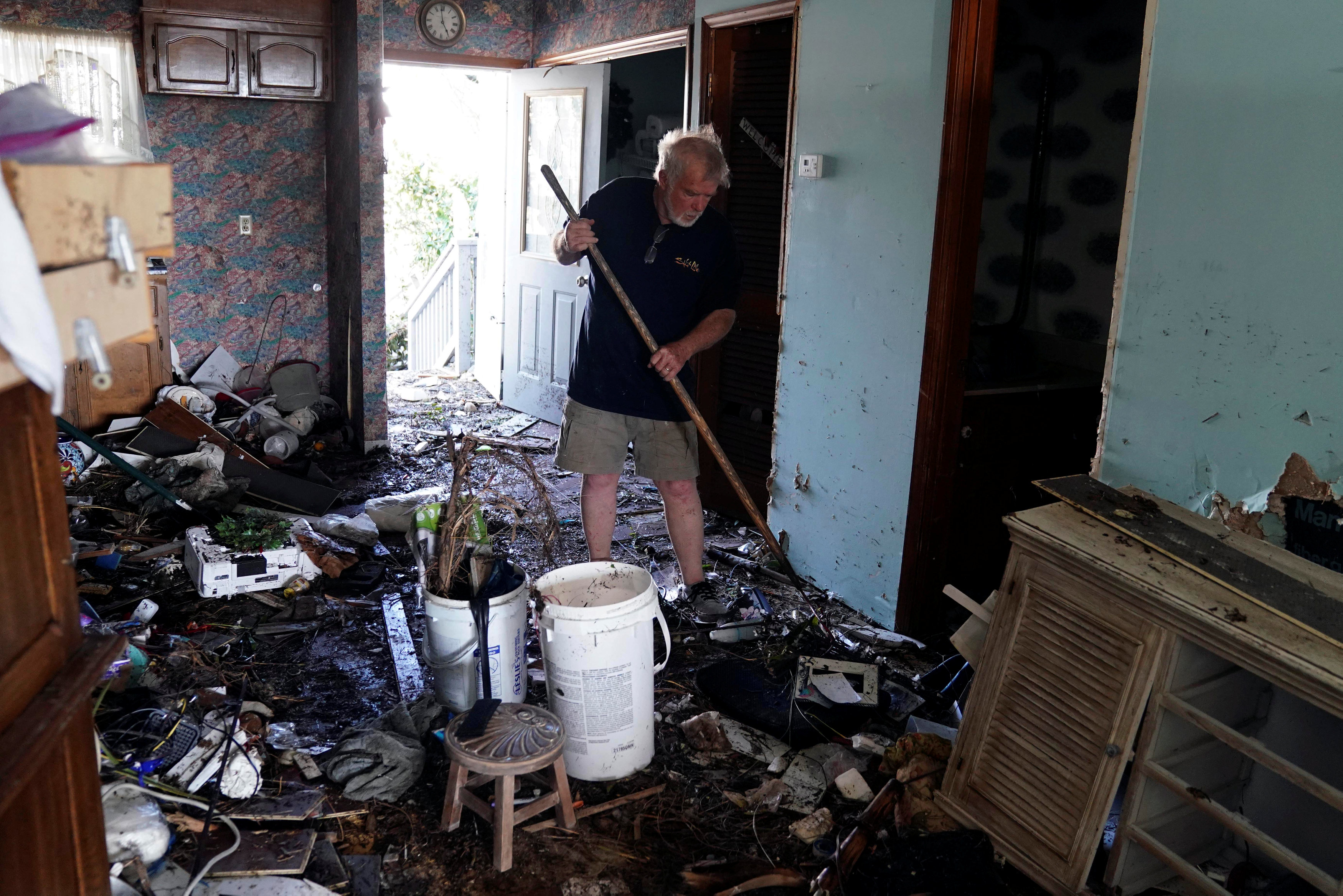 رجل ينظف منزله بعد الزلزال