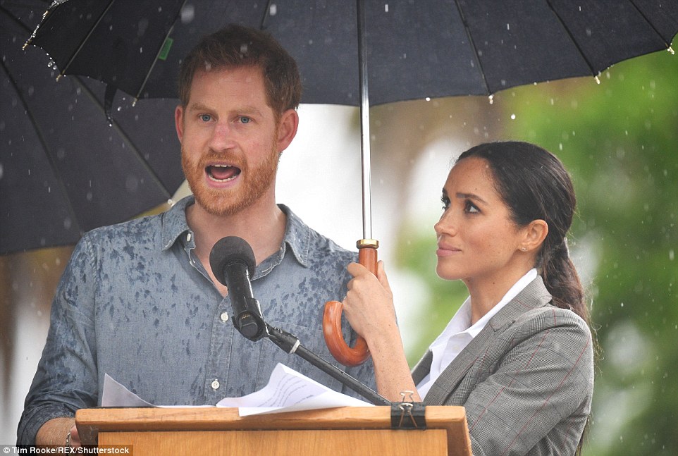 5161086C00000578-6283785-Meghan_Markle_held_an_umbrella_up_for_her_husband_Prince_Harry_a-m-259_1539745069052