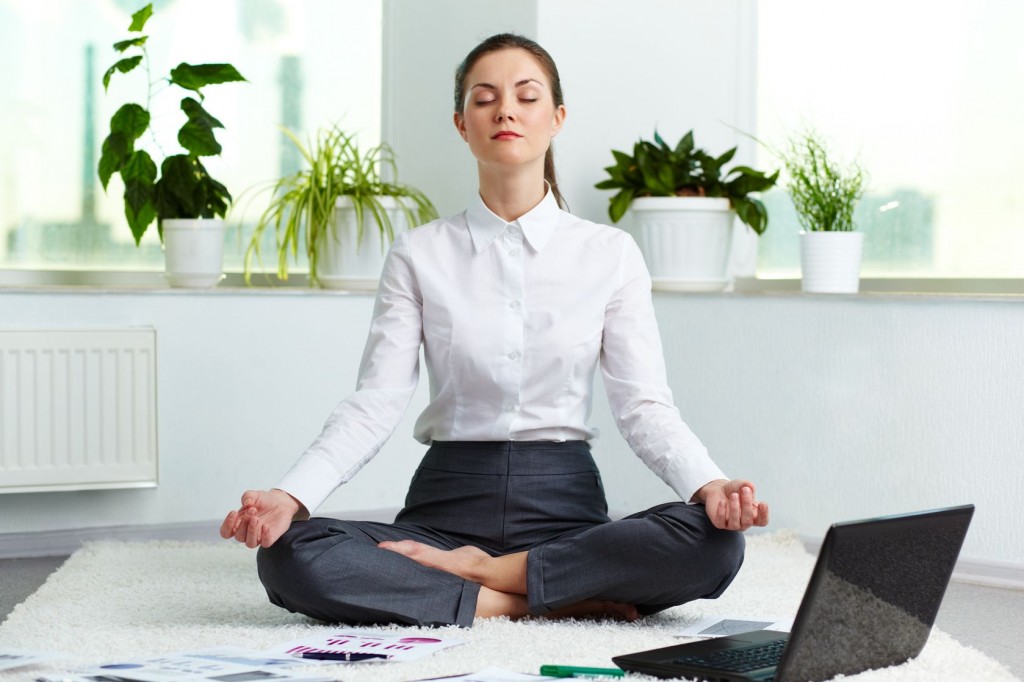 office-woman-meditating-near-laptop-with-plants-in-the-background-1024x682