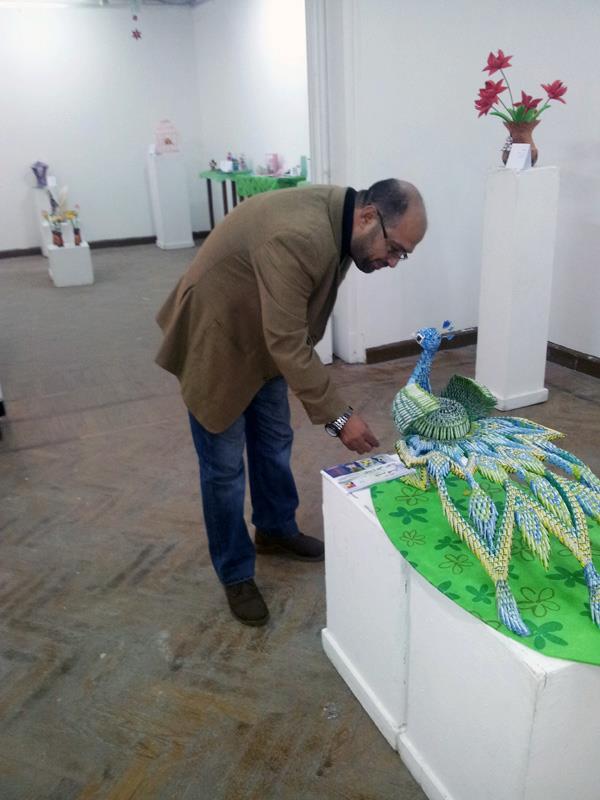 أحد رواد معرض ياسر كمال أثناء تطلعهم على التصميمات