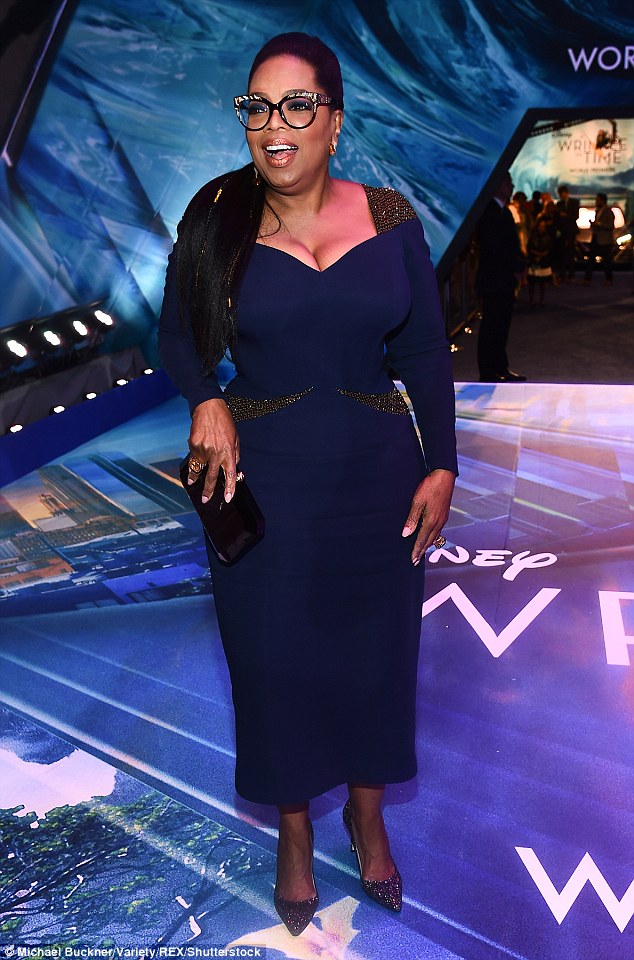 499D9F4400000578-0-Oprah_64_poured_her_curves_into_a_midnight_blue_dress_with_a_low-m-20_1519704773639