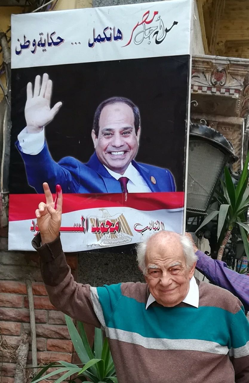 الفنان رشوان توفيق يرفع علامة النصر عقب الإدلاء بصوته فى الانتخابات