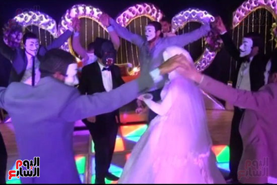 الزميل محمد سعودى يرتدى قناع ويرقص مع عروسته