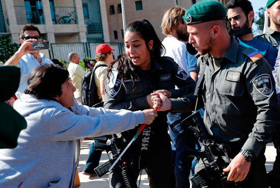 جندى إسرائيلى يعتدى على متظاهرة فلسطينية فى القدس