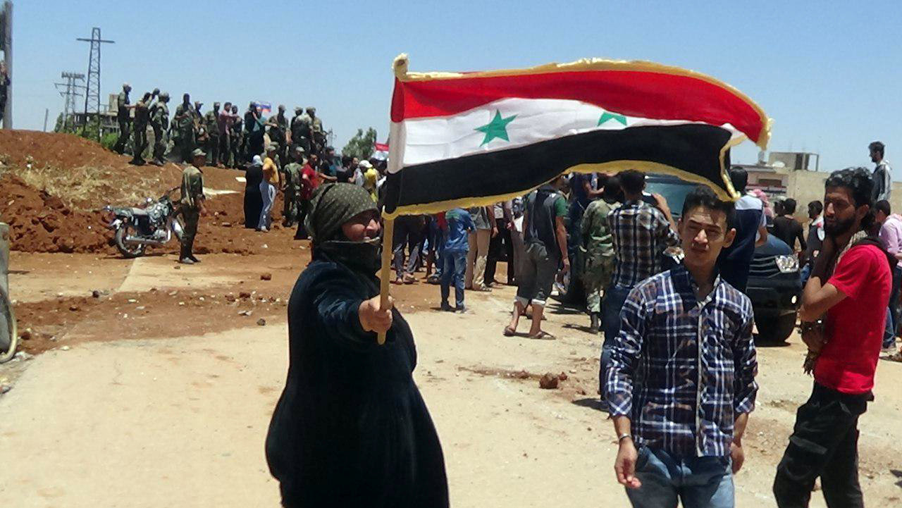 امرأة تحمل علم سوريا