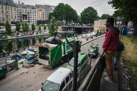 سيارات قمامة تحمل خيام المهاجرين فى باريس