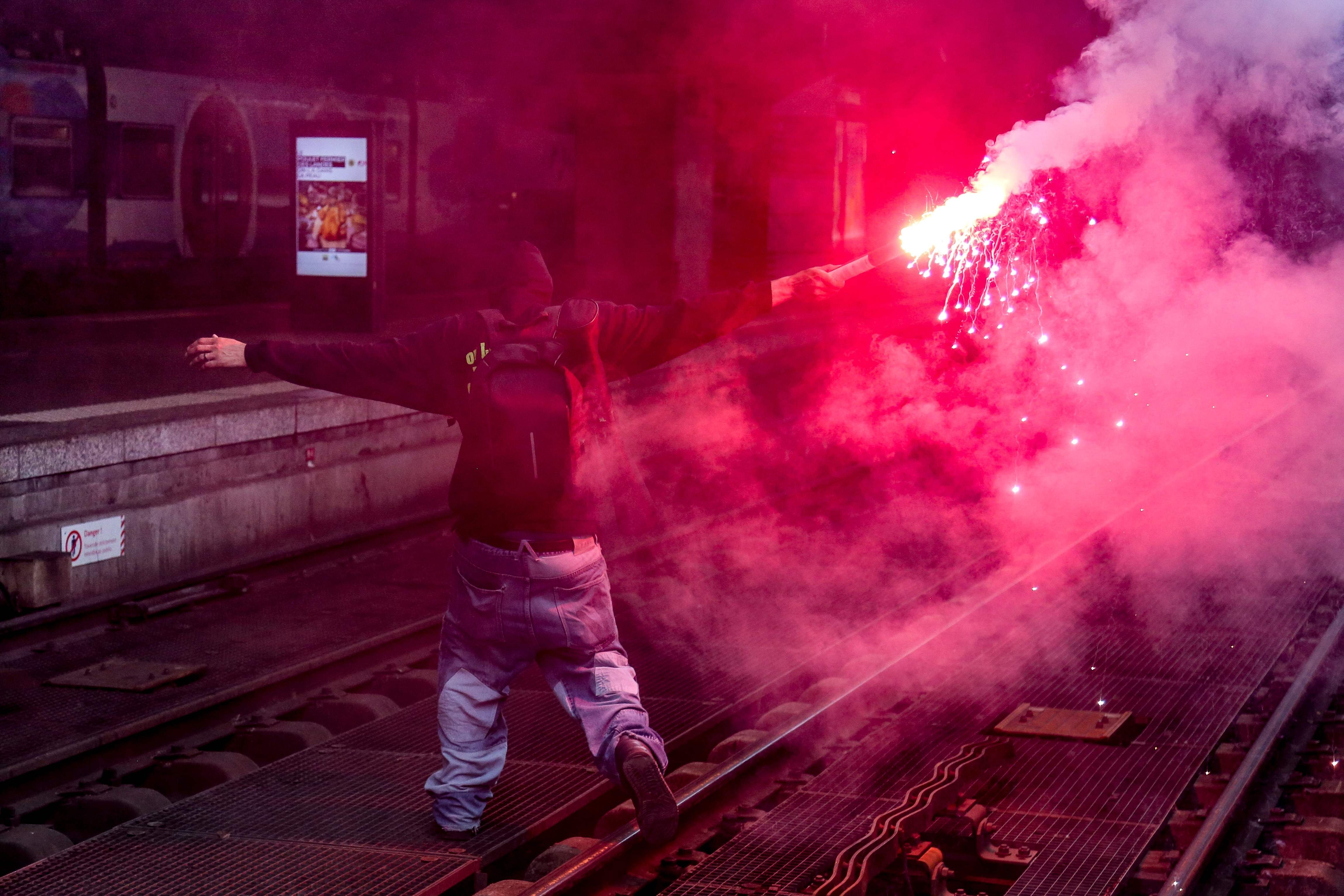 متظاهر يشعل الشماريخ على السكة الحديدية