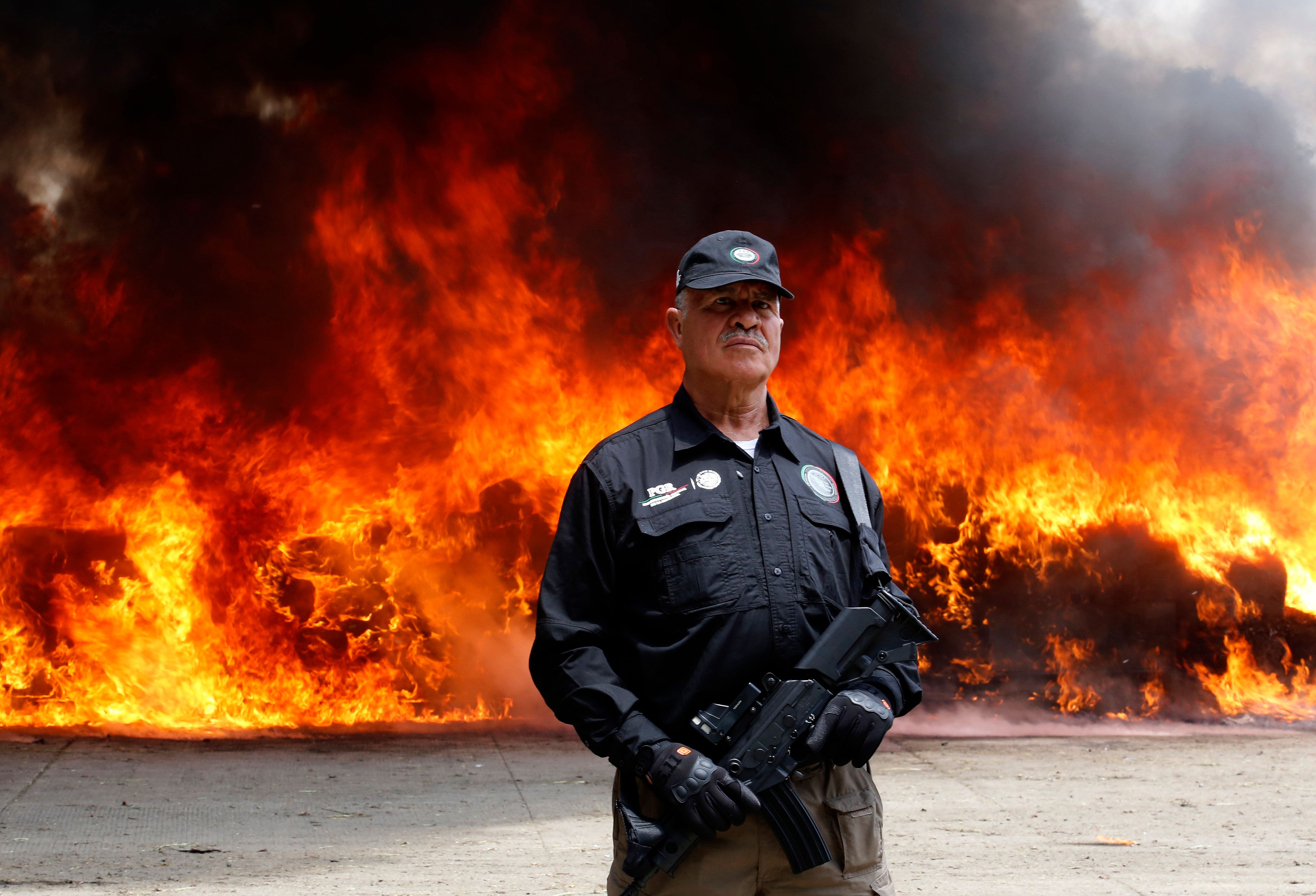 أحد رجال الأمن يلتقط صورة مع الحريق