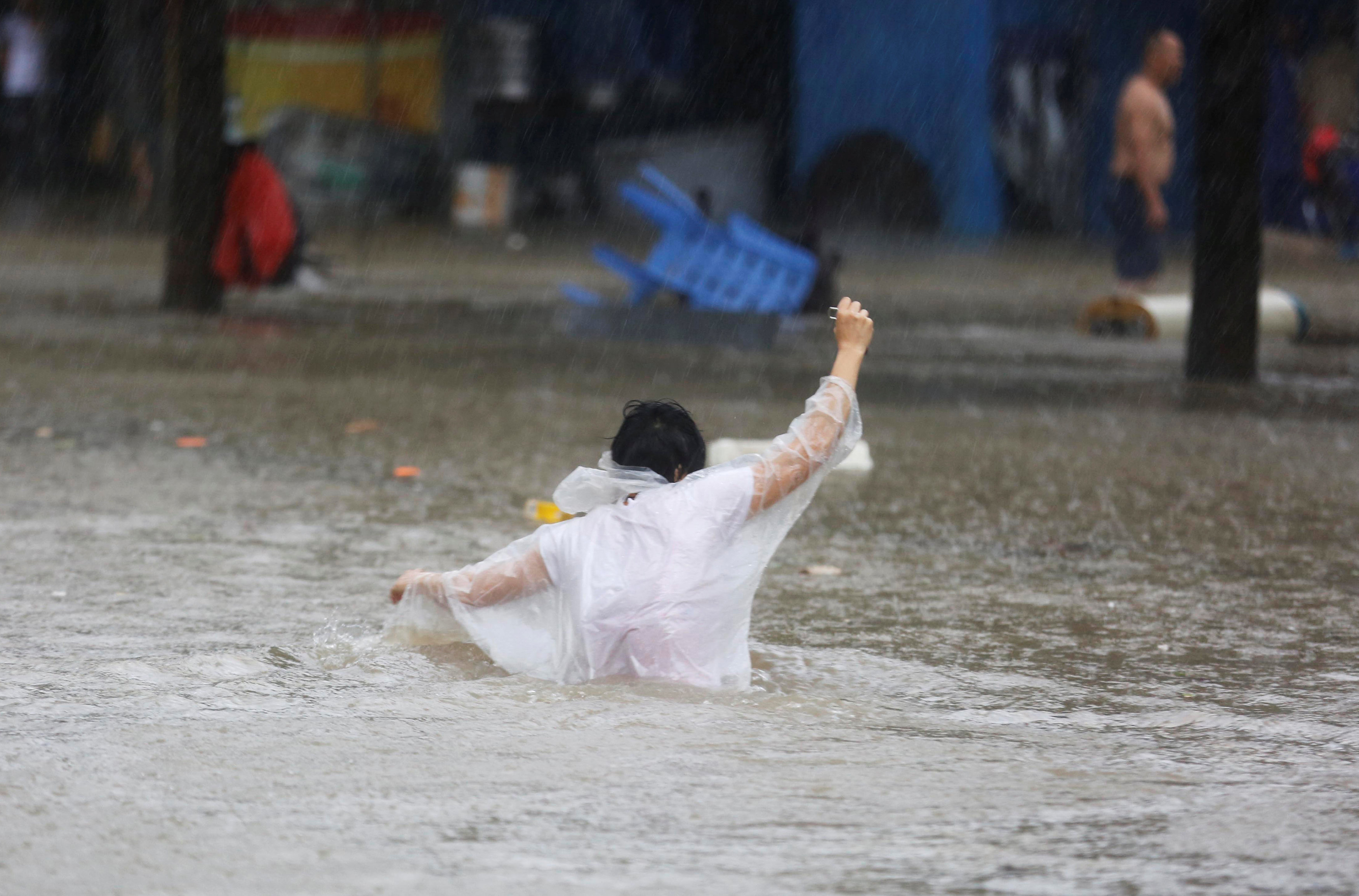 	رجل يسير فى مياه الفيضان 