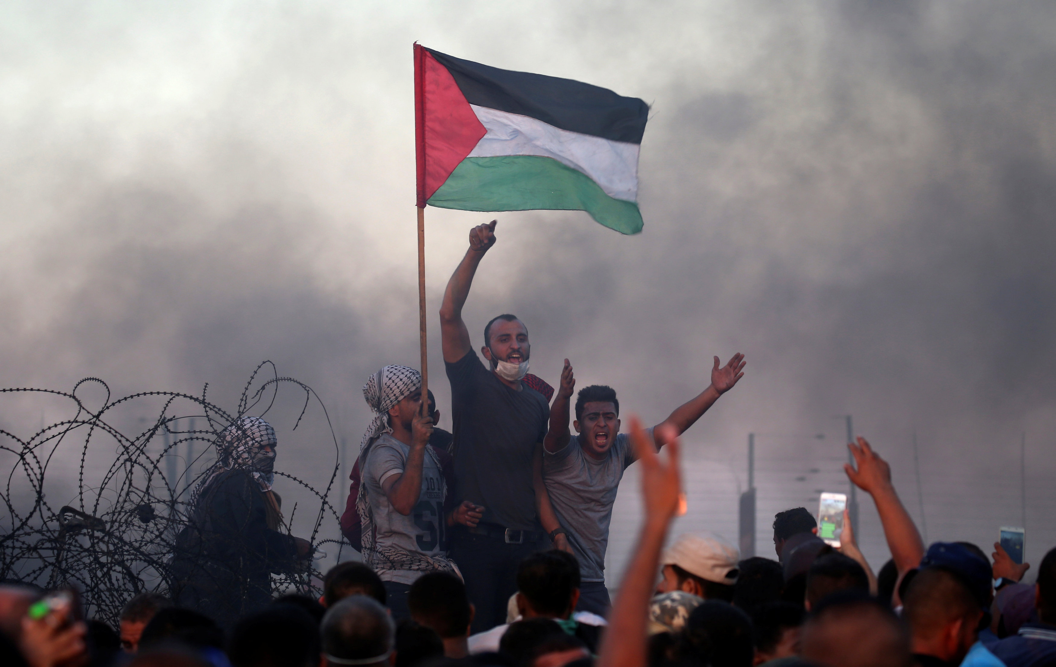 الفلسطينيون يرفعون شعارات خلال احتجاجاتهم على السياج الحدودى
