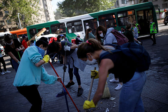 عدد من الطلاب يشاركون فى تنظيف الشوارع