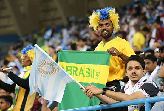 مشجع سعودى يرفع العلم البرازيلى