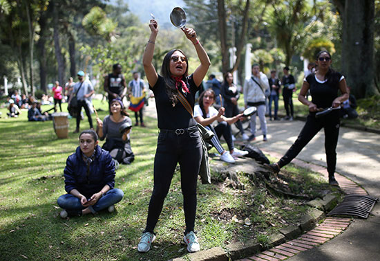متظاهرة تقرع أثناء احتجاج في الحديقة الوطنية مع استمرار الإضراب في بوجوتا